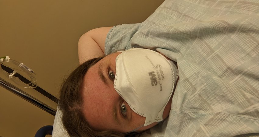 A picture of me chilling out in my hospital gown and N95 mask waiting to get my endoscopy.