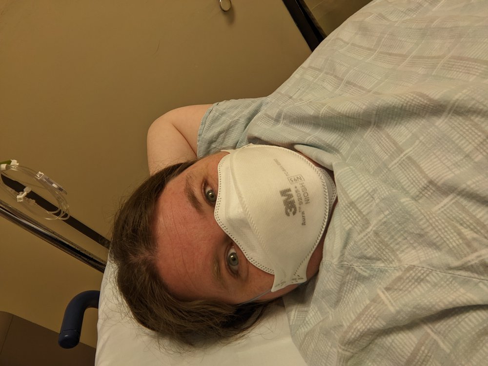 A picture of me chilling out in my hospital gown and N95 mask waiting to get my endoscopy.